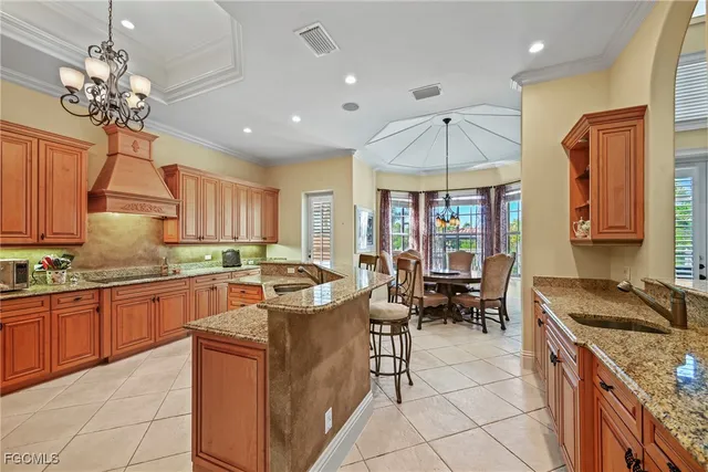 a kitchen with stainless steel appliances granite countertop a sink and a refrigerator