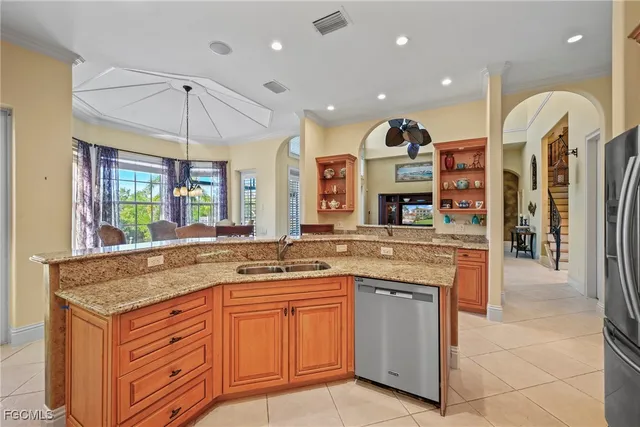 a dining room with furniture a chandelier and window