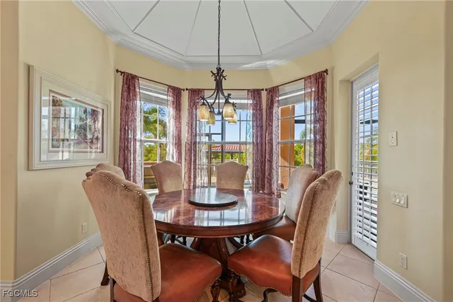 a living room with furniture a dining table and a chandelier