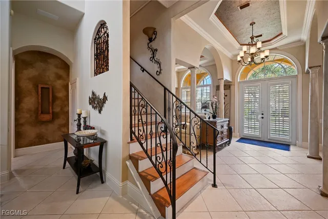 a bedroom with a bed couch and wooden floor