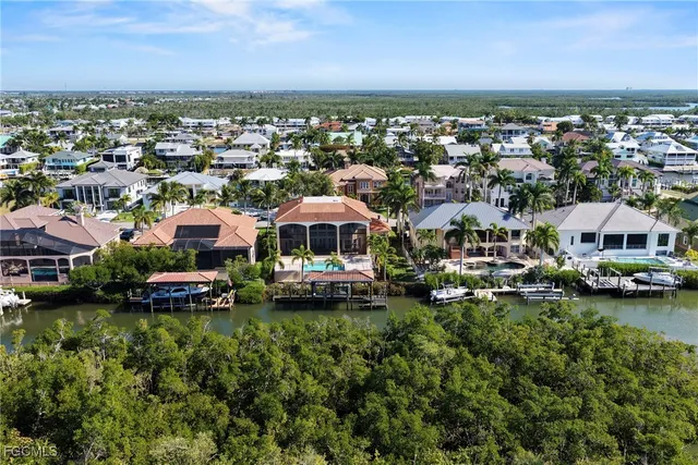 a view of a house with a yard and a garage