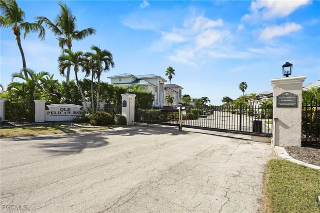 an aerial view of ocean and residential houses with outdoor space