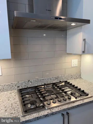 an empty room with wooden floor and closet