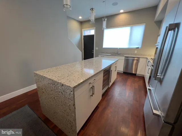 en empty room with wooden floor and ceiling fan