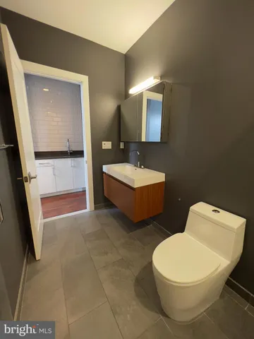 a bathroom with a tub sink and mirror