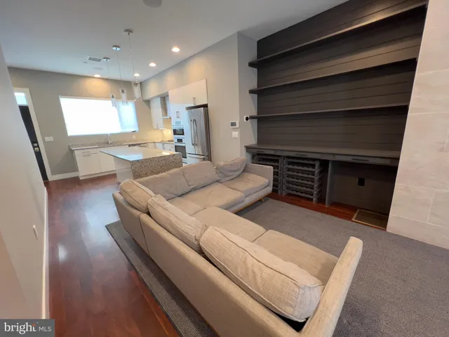 a living room with a flat screen tv and a fireplace