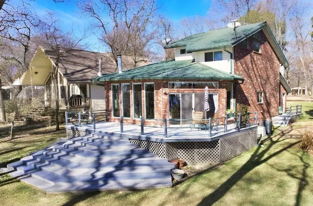 a view of a house with backyard porch and sitting area