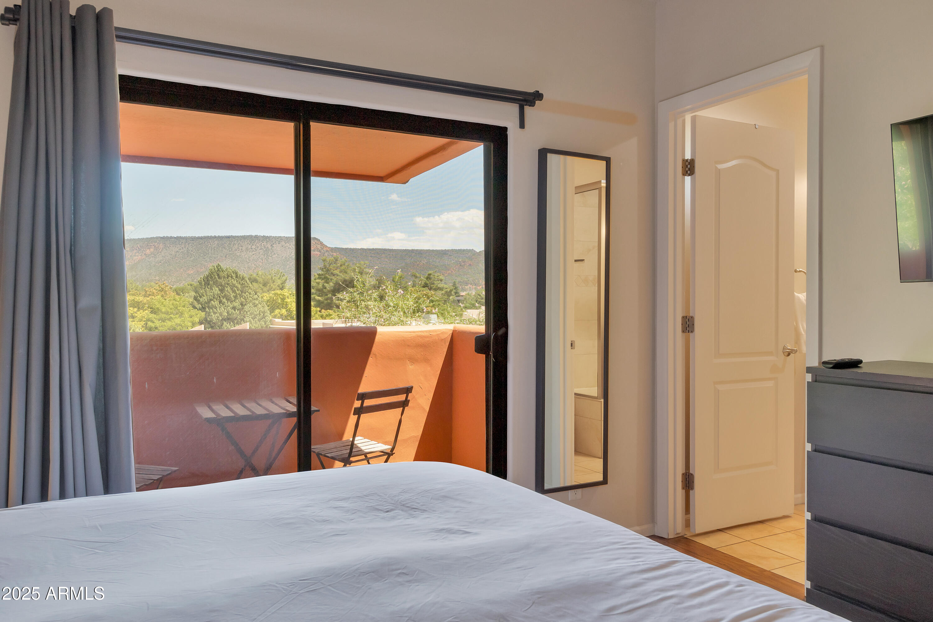 45 Canyon Diablo Road, Unit 4 Sedona, AZ 86351 - Photo 13 of 23 a bedroom with a large window and a bed