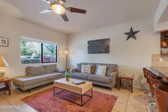 a living room with furniture a rug and a chandelier