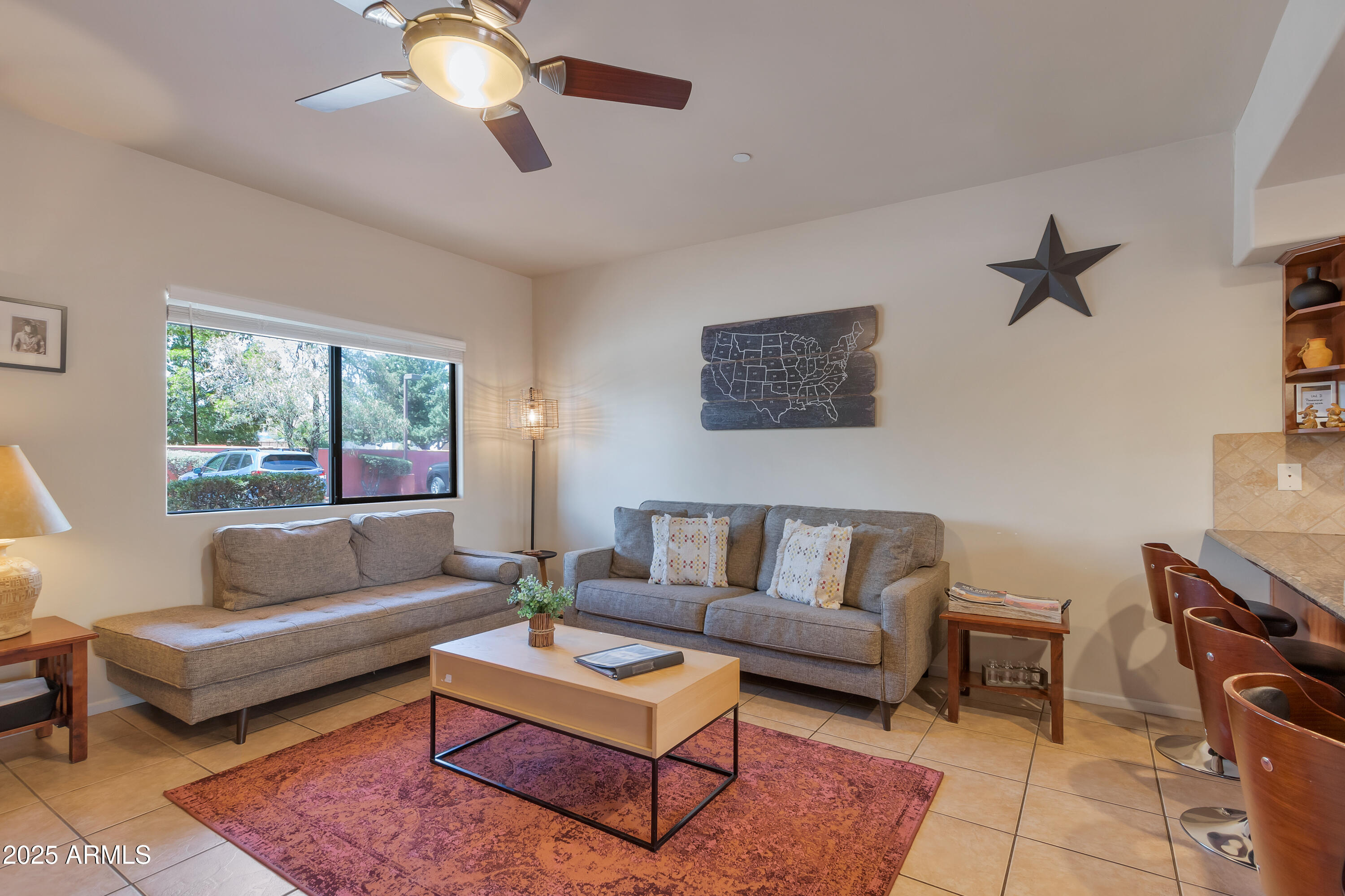 45 Canyon Diablo Road, Unit 4 Sedona, AZ 86351 - Photo 5 of 23 a living room with furniture a rug and a chandelier
