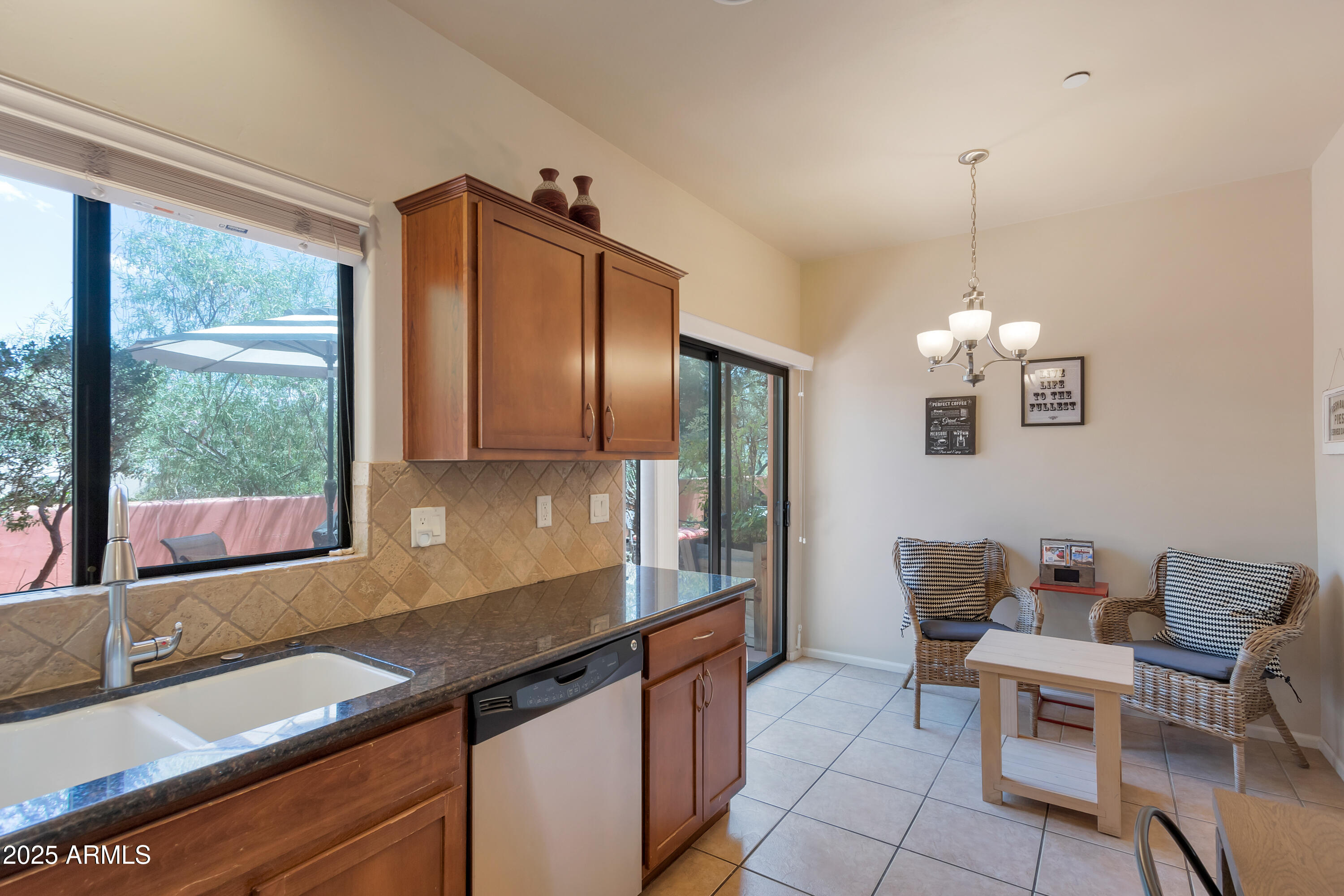 45 Canyon Diablo Road, Unit 4 Sedona, AZ 86351 - Photo 7 of 23 a kitchen with granite countertop a sink dining table and chairs