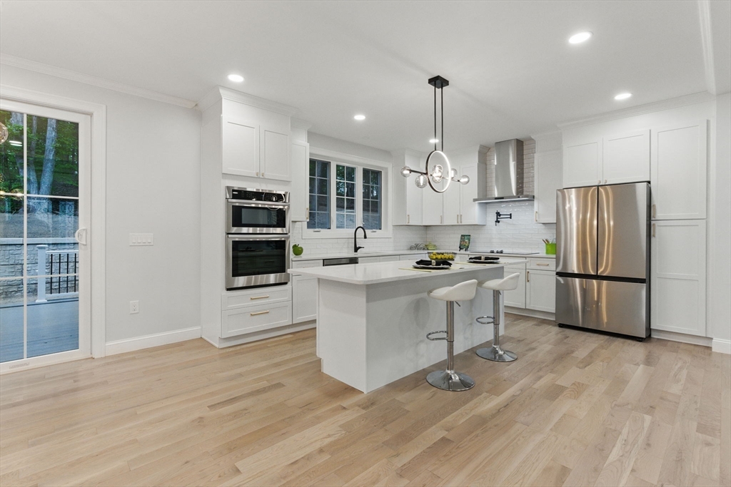 835 West Street Ludlow, MA 01056 - Photo 11 of 42 a kitchen with white cabinets and stainless steel appliances