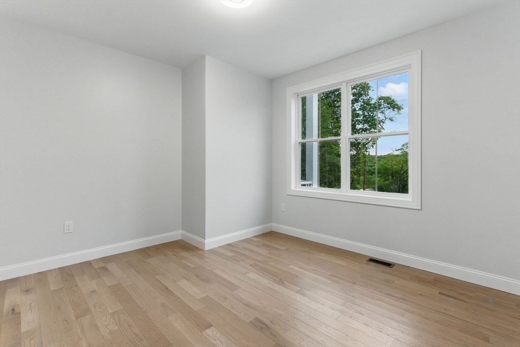835 West Street Ludlow, MA 01056 - Photo 18 of 42 a view of an empty room with wooden floor and a window