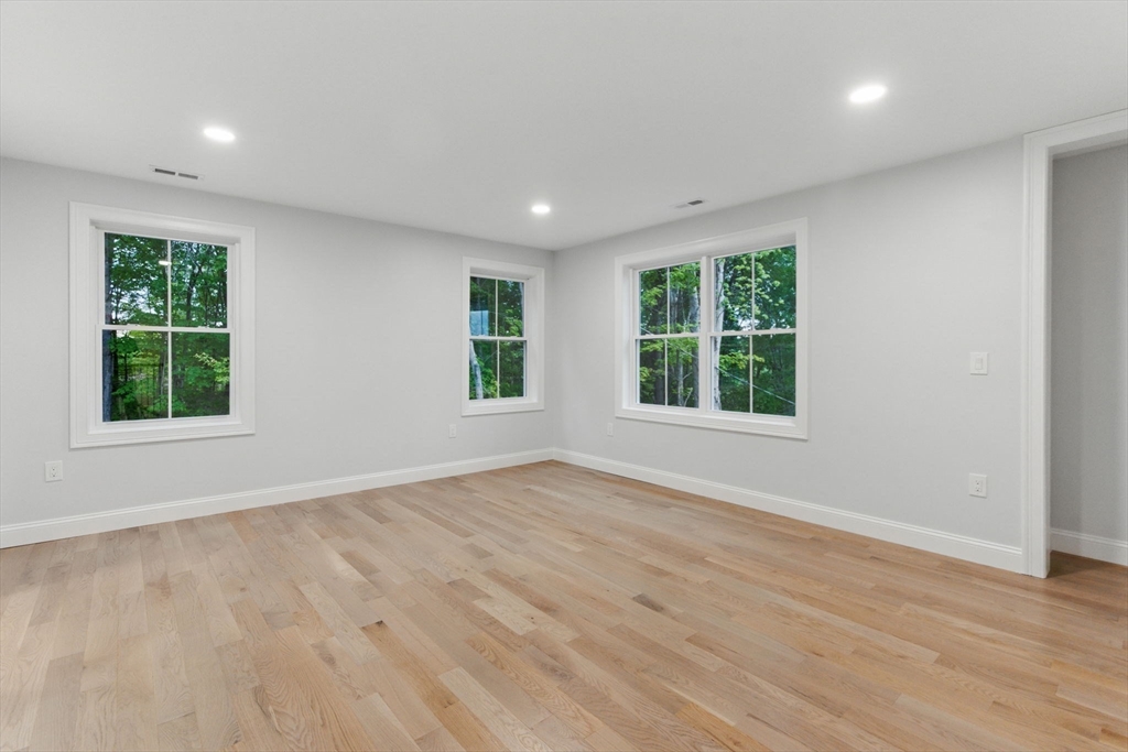 835 West Street Ludlow, MA 01056 - Photo 21 of 42 an empty room with wooden floor and windows