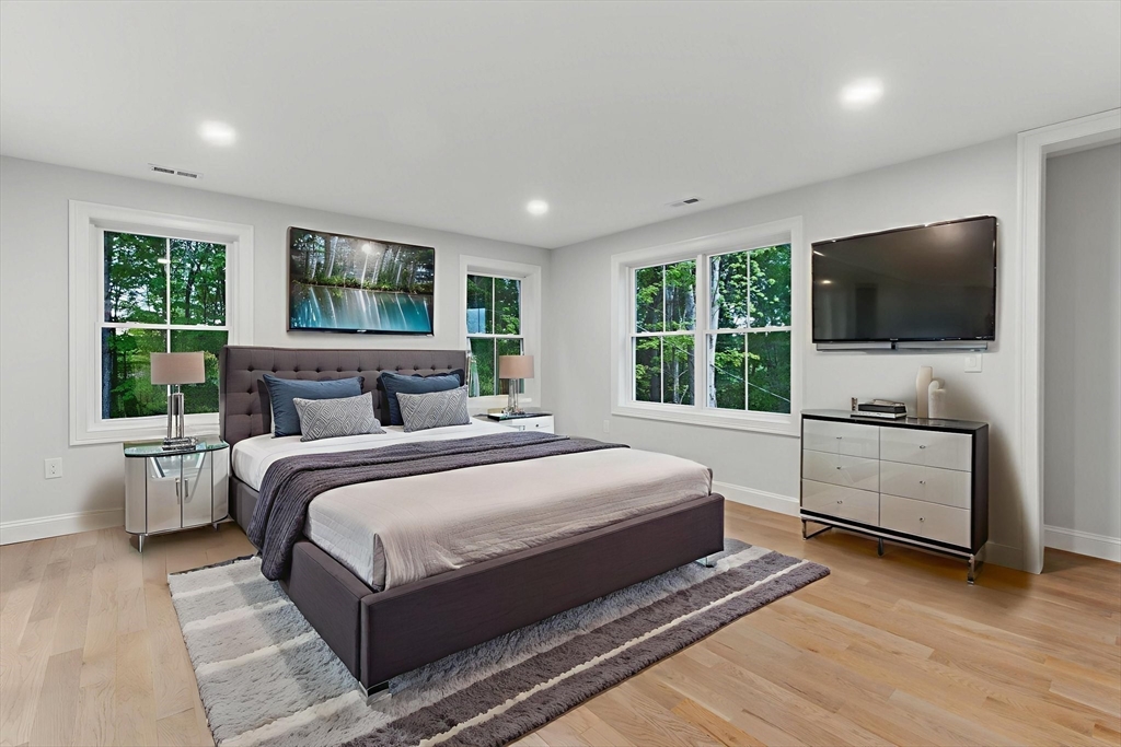 835 West Street Ludlow, MA 01056 - Photo 22 of 42 a bedroom with a large bed and a flat screen tv