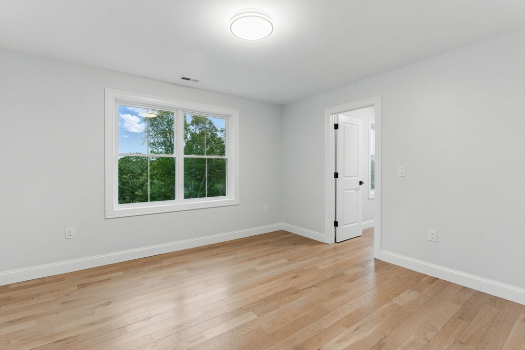 835 West Street Ludlow, MA 01056 - Photo 32 of 42 a view of an empty room with wooden floor and a window