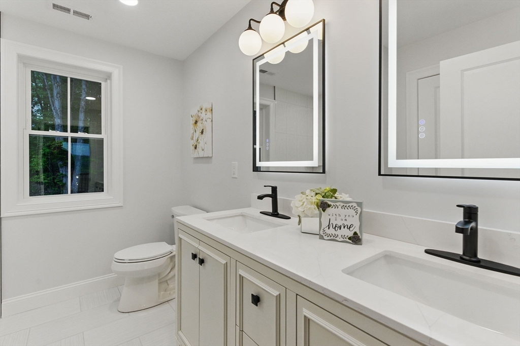 835 West Street Ludlow, MA 01056 - Photo 33 of 42 a bathroom with a sink a toilet and a mirror