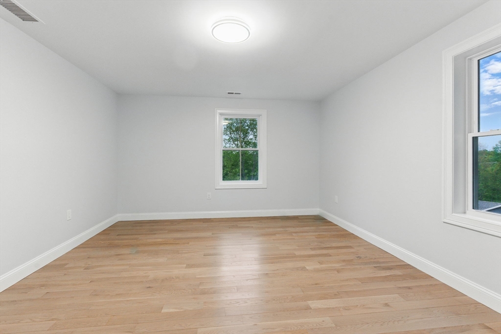 835 West Street Ludlow, MA 01056 - Photo 39 of 42 an empty room with wooden floor and windows