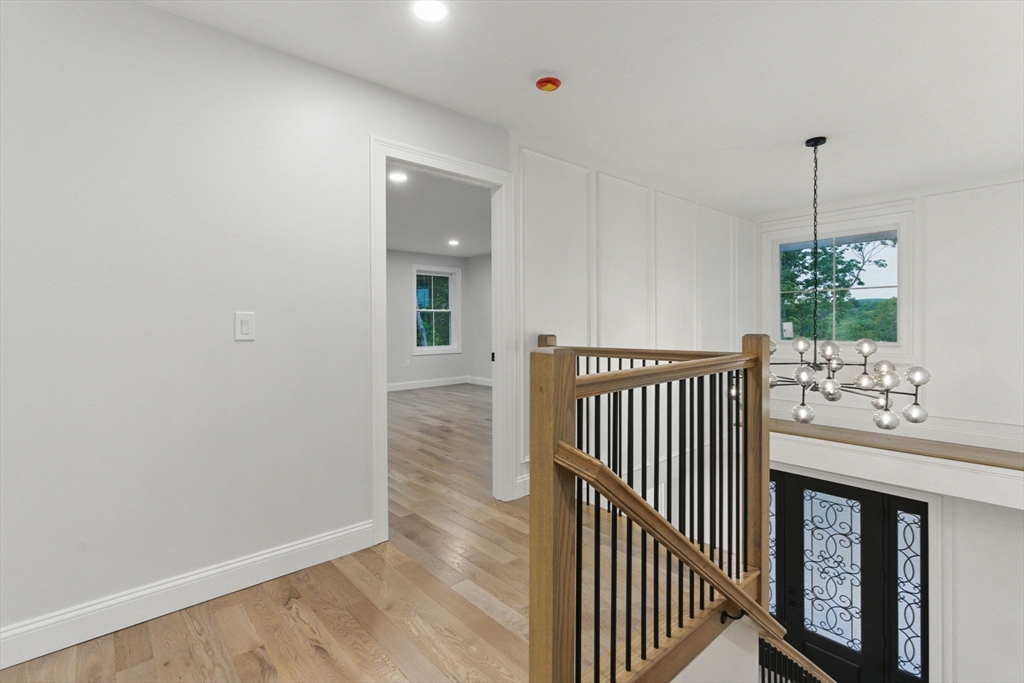 835 West Street Ludlow, MA 01056 - Photo 40 of 42 a view of a hallway with wooden floor and a chandelier