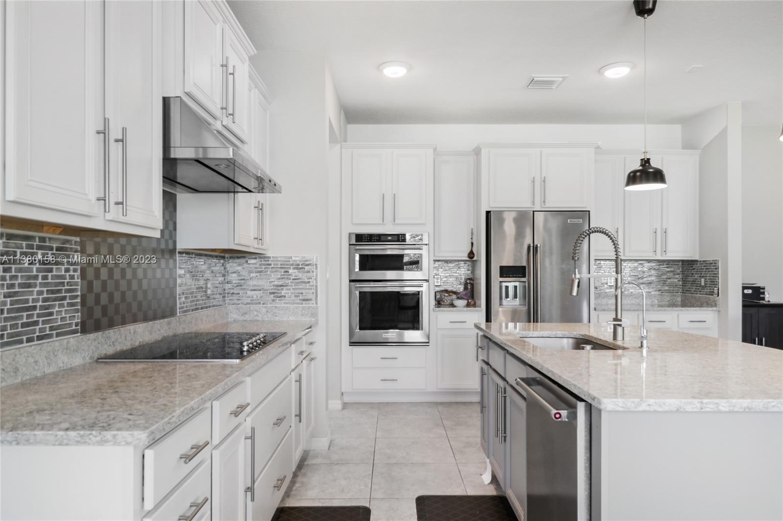 1348 Silk Oak Drive Hollywood, FL 33021 - Photo 15 of 33 a kitchen with stainless steel appliances granite countertop a sink and refrigerator