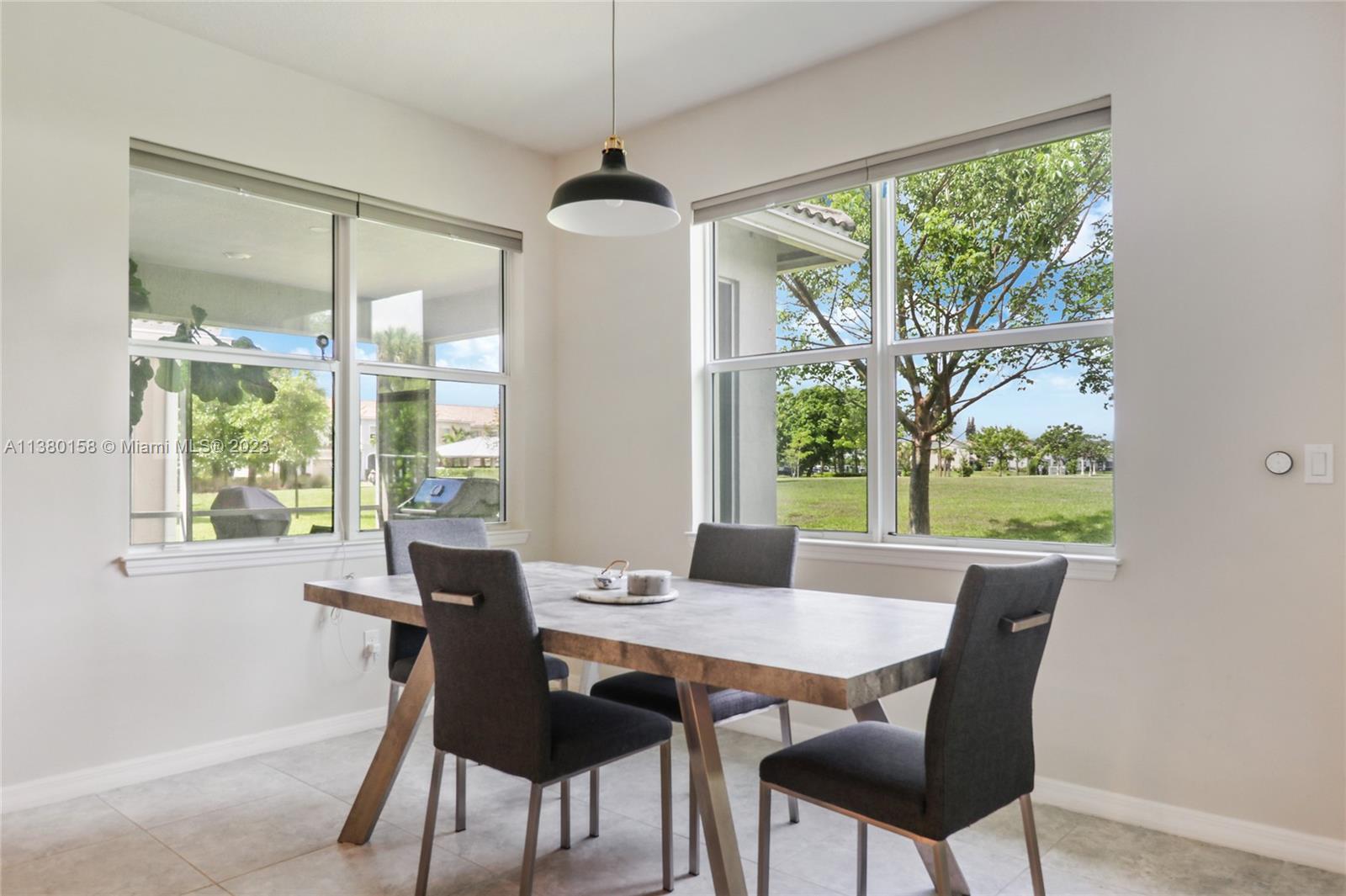 1348 Silk Oak Drive Hollywood, FL 33021 - Photo 16 of 33 a view of a dining room with furniture a chandelier and wooden floor