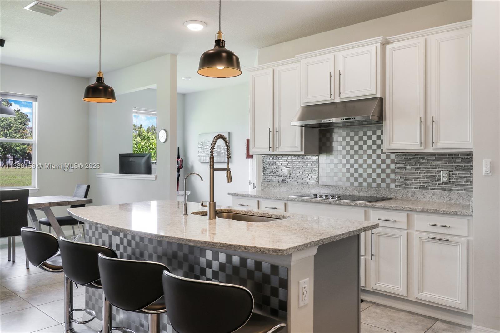 1348 Silk Oak Drive Hollywood, FL 33021 - Photo 17 of 33 a kitchen with granite countertop a sink a counter space appliances and cabinets