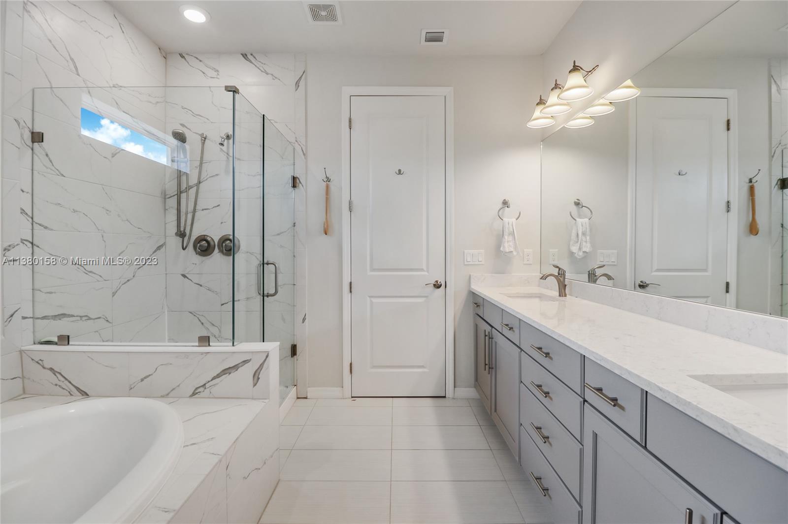 1348 Silk Oak Drive Hollywood, FL 33021 - Photo 25 of 33 a spacious bathroom with a double vanity sink mirror and shower