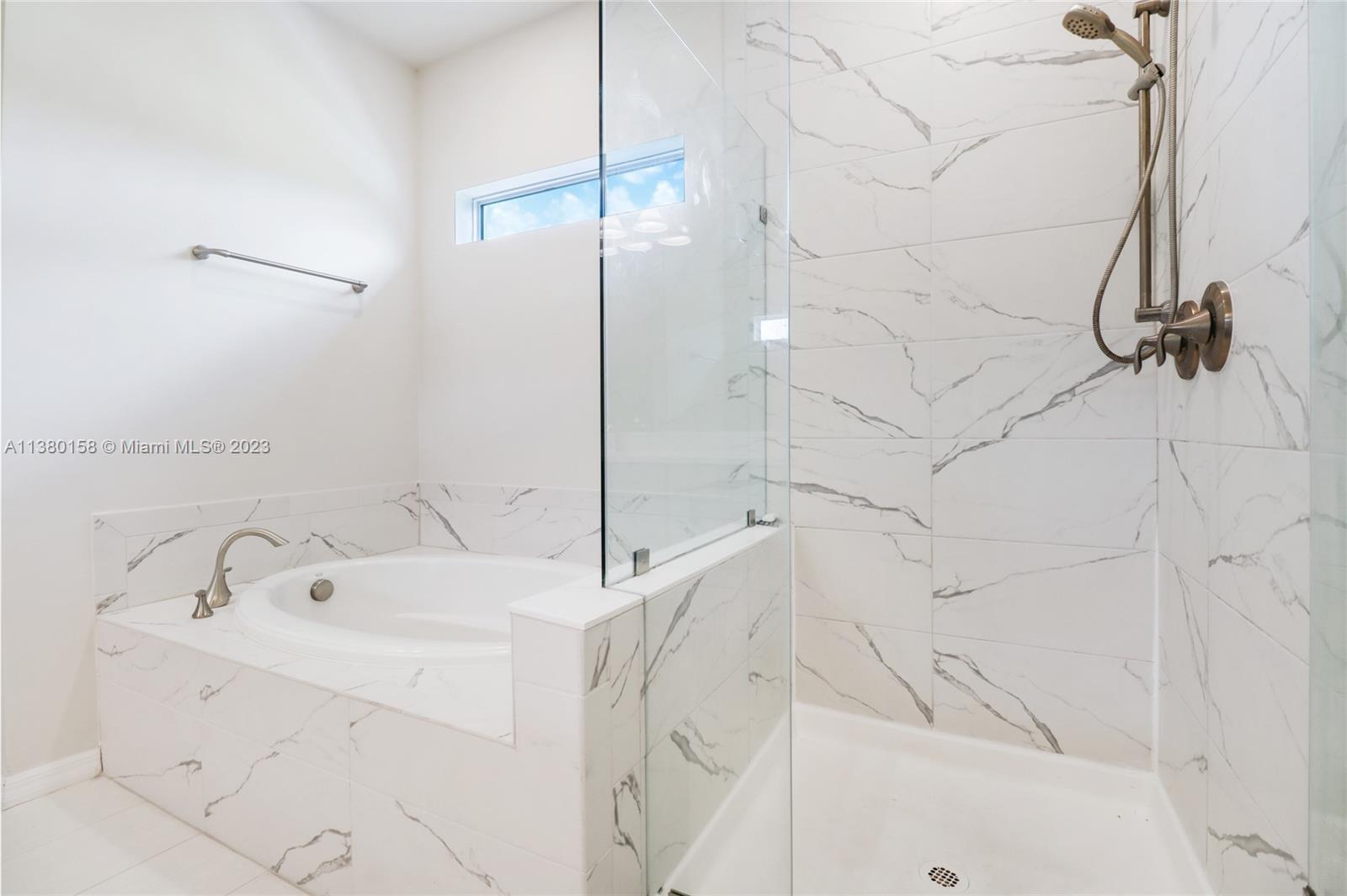 1348 Silk Oak Drive Hollywood, FL 33021 - Photo 28 of 33 a bathroom with a bathtub and a shower