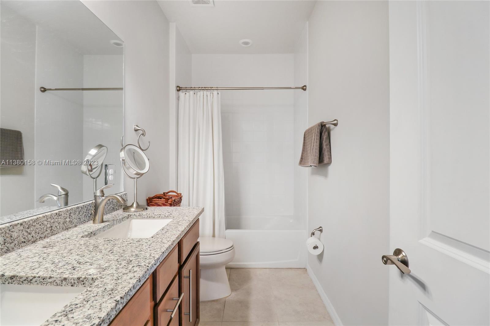 1348 Silk Oak Drive Hollywood, FL 33021 - Photo 29 of 33 a bathroom with a granite countertop sink a toilet and shower