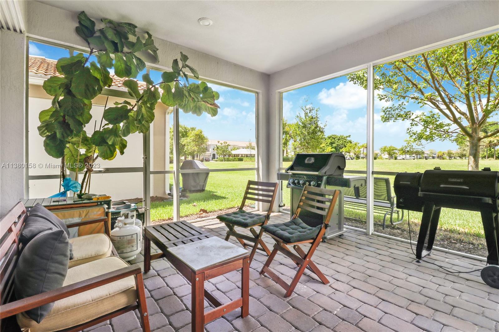 1348 Silk Oak Drive Hollywood, FL 33021 - Photo 32 of 33 a view of a terrace with furniture and a yard