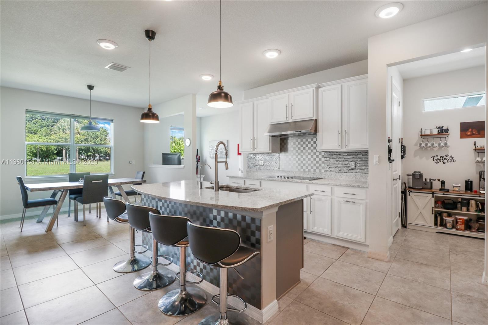 1348 Silk Oak Drive Hollywood, FL 33021 - Photo 10 of 33 a large kitchen with a large counter top furniture a sink a window and appliances