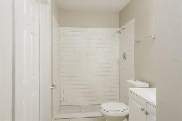 a white toilet sitting next to a bathroom sink