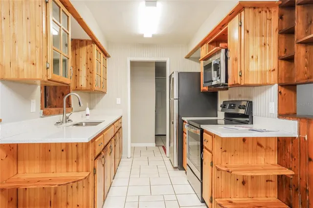 a kitchen with stainless steel appliances granite countertop a sink and cabinets