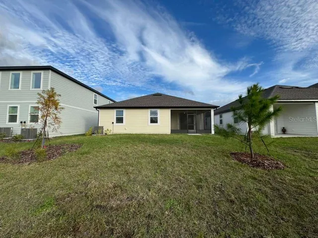 a view of a backyard of the house