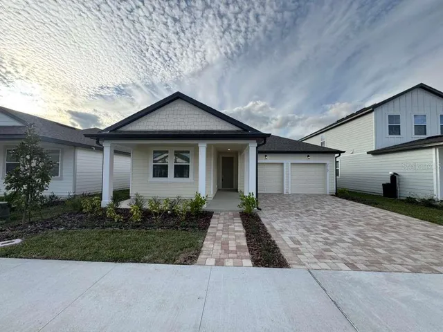 a front view of house with yard and trees around