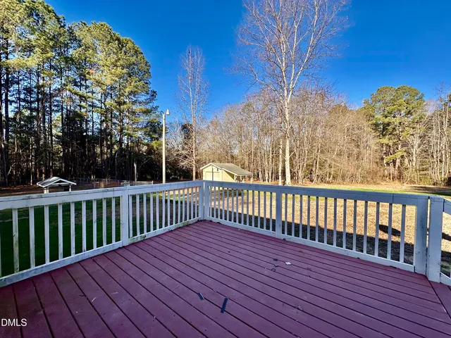 a view of a yard with large trees