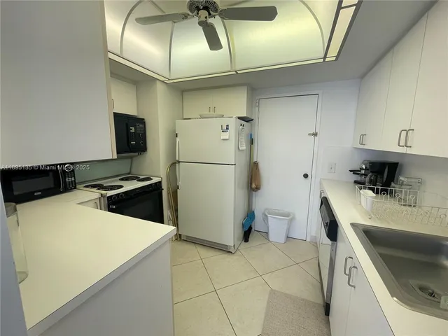 a kitchen with a refrigerator and a sink