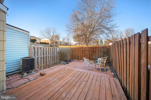 a view of backyard with wooden floor and fence