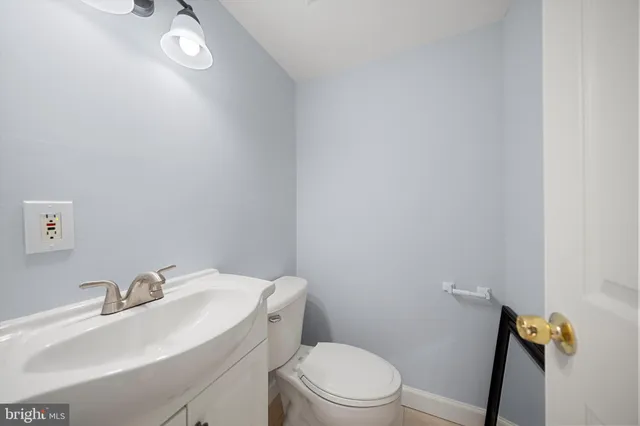 a bathroom with a sink toilet and a mirror