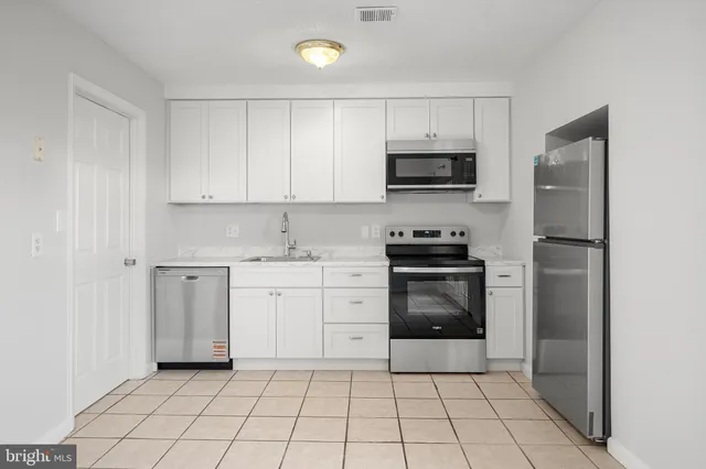 a kitchen with a sink a stove and refrigerator