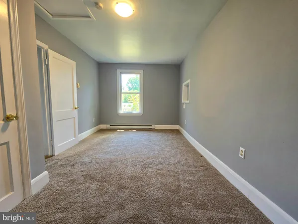 a living room with furniture a lamp and a window