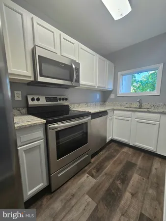 a kitchen with a refrigerator and a stove