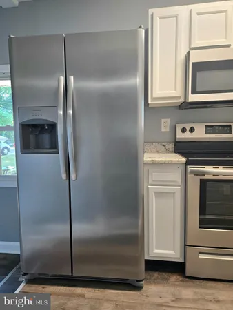 a utility room with cabinets washer and dryer