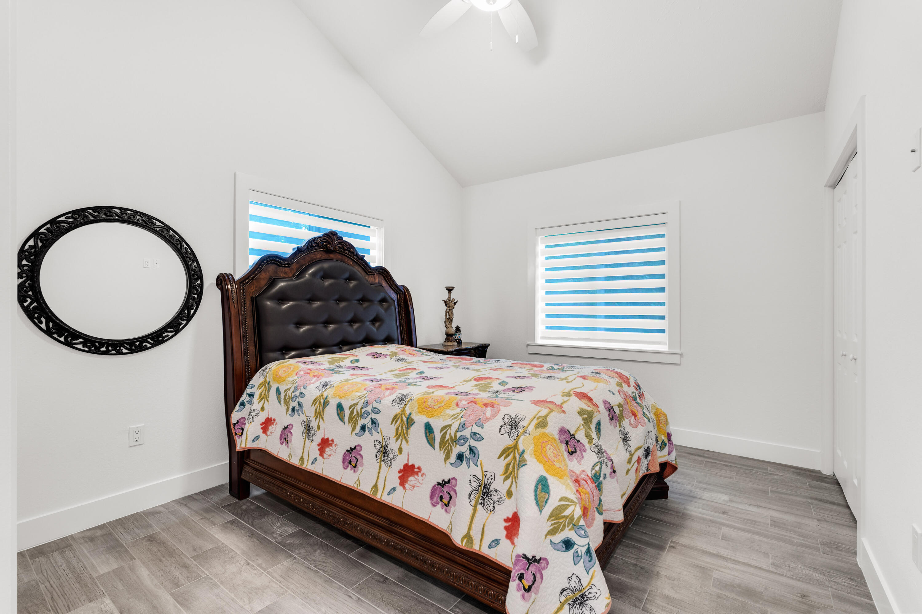 1023 Valencia Road Key Largo, FL 33037 - Photo 22 of 32 a bedroom with a bed a mirror and a window