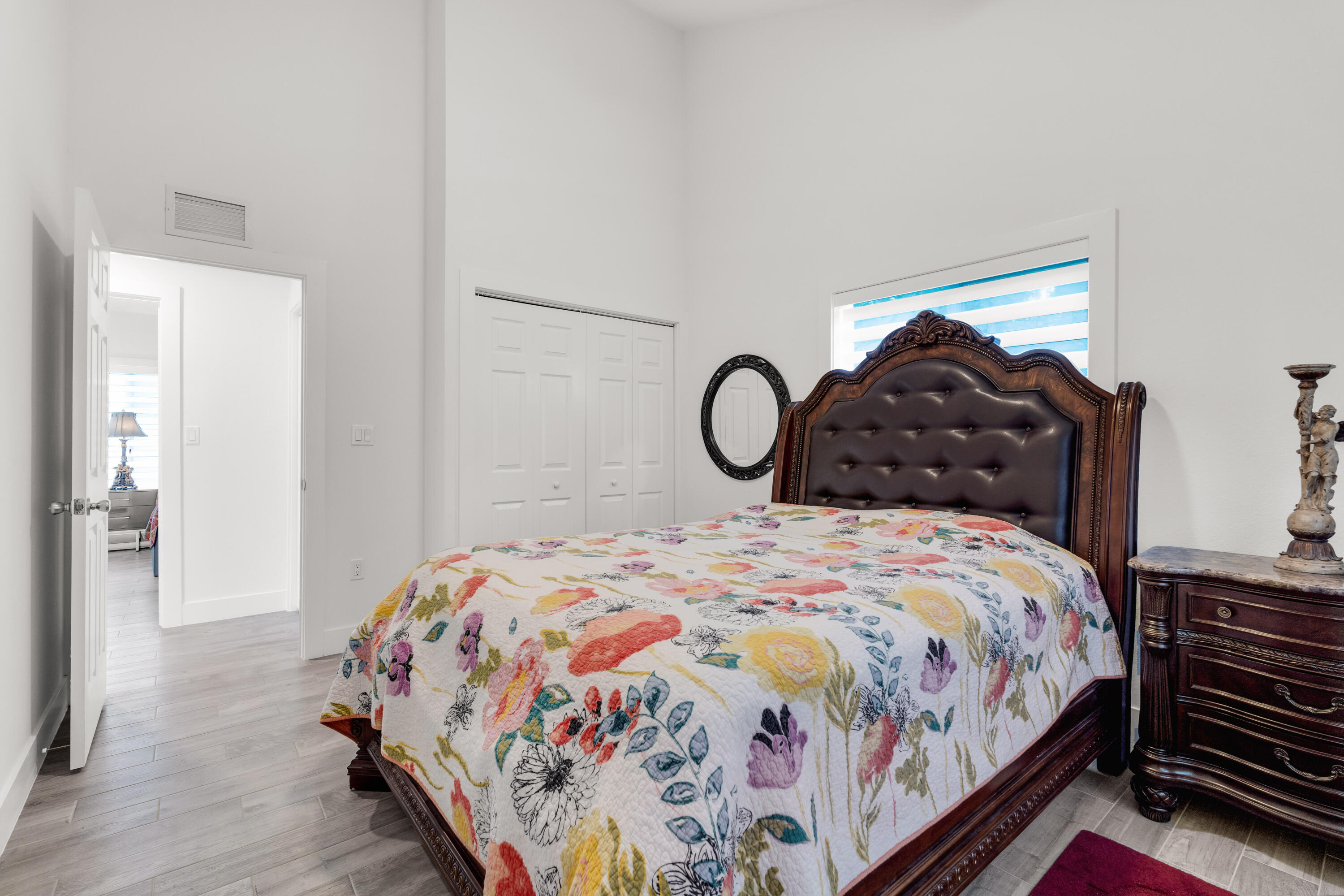 1023 Valencia Road Key Largo, FL 33037 - Photo 23 of 32 a bedroom with a bed and wooden floor