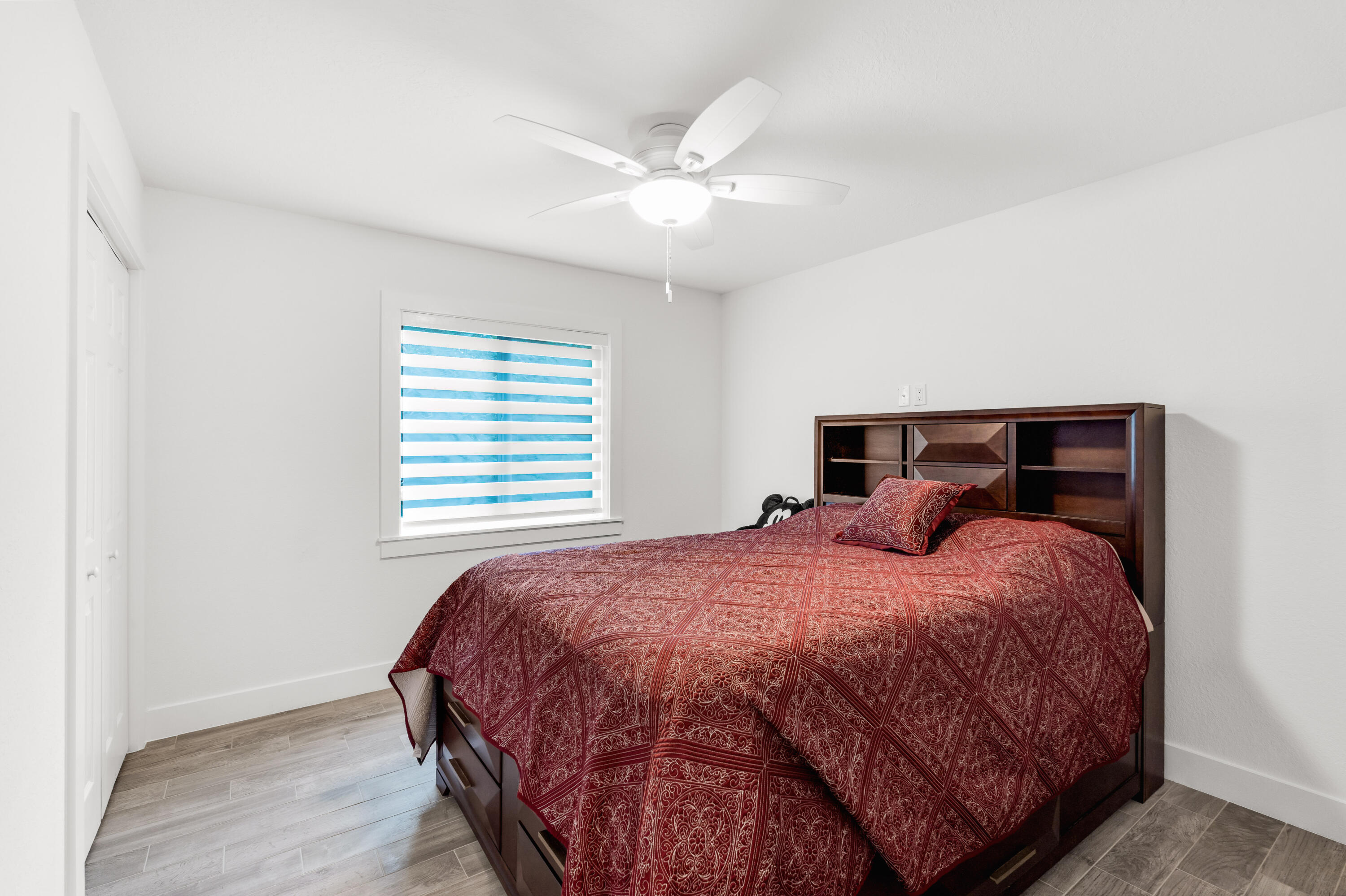 1023 Valencia Road Key Largo, FL 33037 - Photo 24 of 32 a bedroom with a bed and a ceiling fan