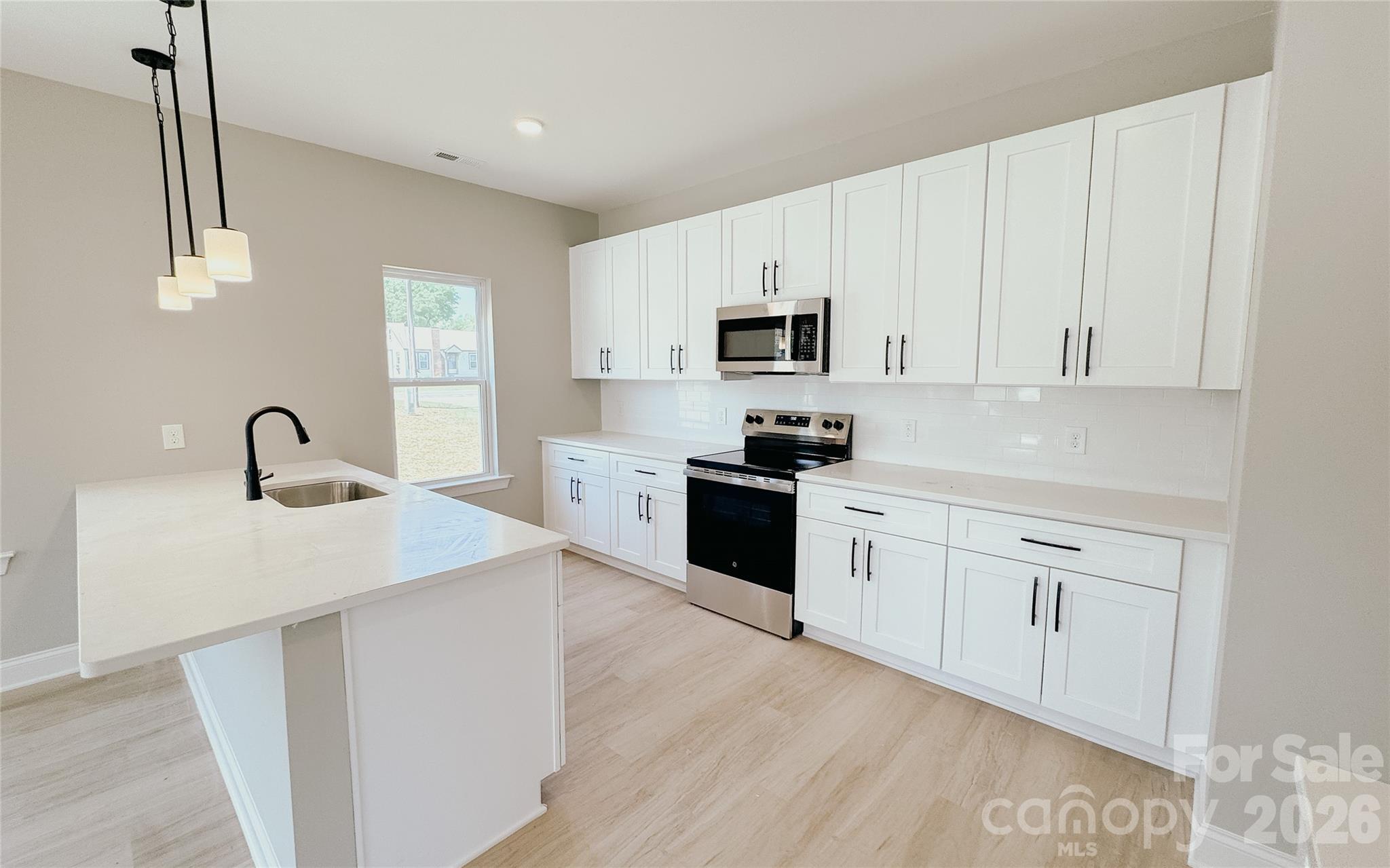 1455 West Ridge Road Salisbury, NC 28147 - Photo 6 of 26 a kitchen with white cabinets and appliances