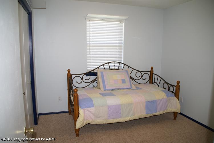 4816 South Austin Street Amarillo, TX 79110 - Photo 8 of 14 a bedroom with a bed and window