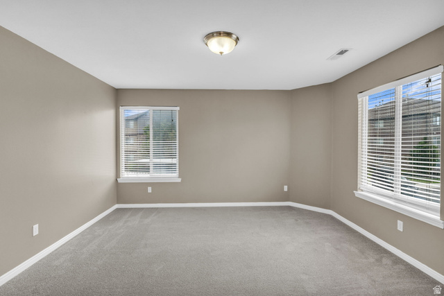 656 South 910 West, Unit 25 Pleasant Grove, UT 84062 - Photo 15 of 25 Spacious room featuring neutral painted walls, light grey carpeting, and white baseboards.