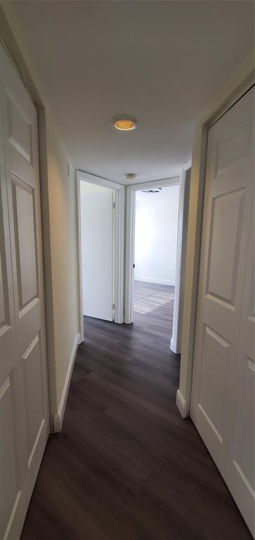 8781 Wiles Road, Unit 308 Coral Springs, FL 33067 - Photo 13 of 24 an empty room with wooden floor and windows